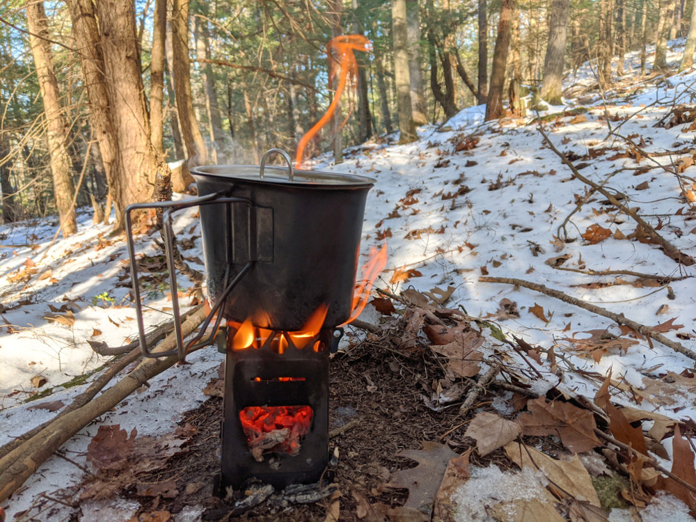 a kettle by a canoe campfire