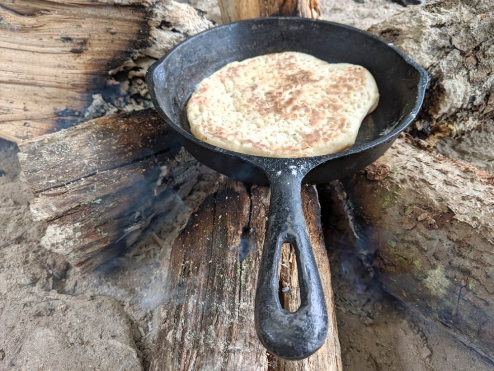 flatbread baking in an iron skillet